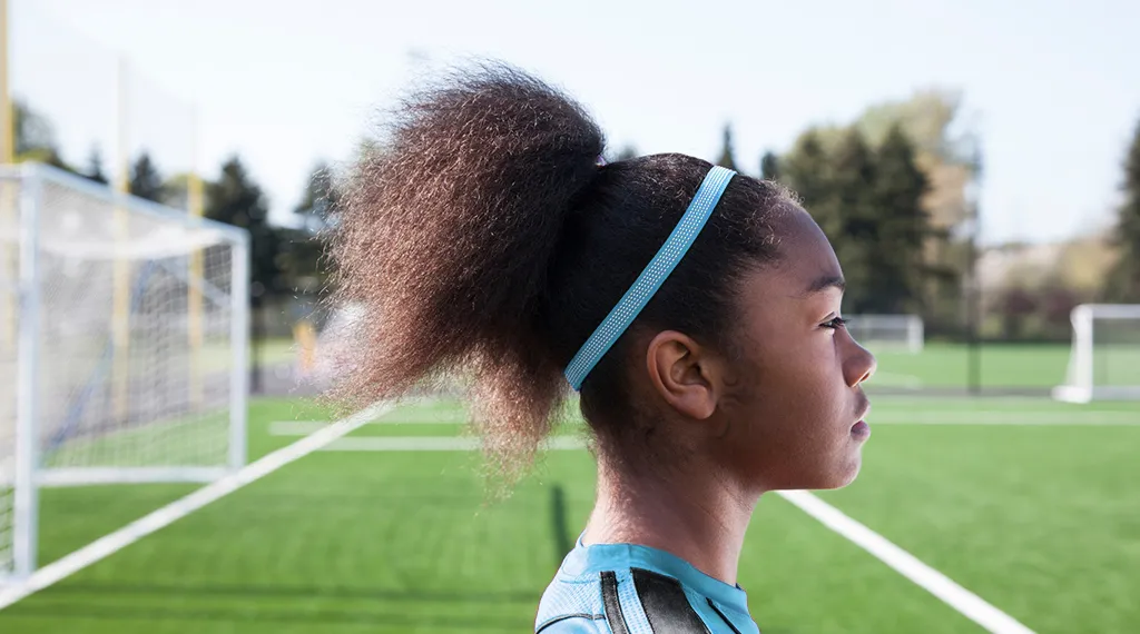 Girl standing on a soccer field